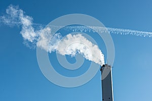 Steam rising from a tall chimney..