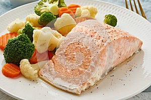 Steam salmon and vegetables, Paleo, keto, fodmap, dash diet. Mediterranean diet with steamed vegetables and fish. Healthy concept
