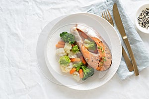 Steam salmon and vegetables, top view, copy space. Paleo, keto, fodmap, dash diet.