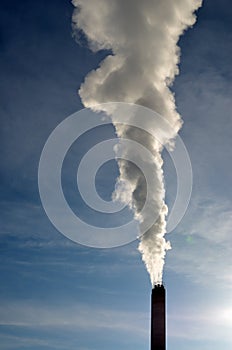 Steam from stack against blue sky