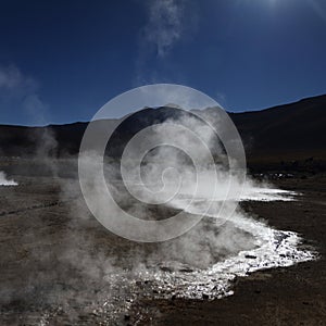 Steam with sun reflection on the water in El Tatio Chile