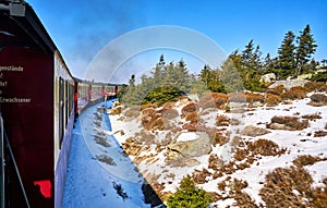 Steam train on the Brocken mountain with snow in winter. Dynamics through motion blur