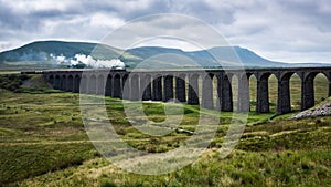 A Steam train crosses a viaduct in Yorkshire photo
