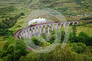 Steam train on a famous Glenfinnan viaduct, Scotland