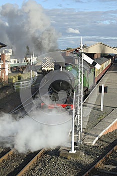 Steam train leaving station