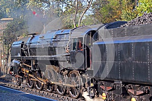 Steam train or locomotive with coal tender.