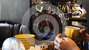 The steam wand from the coffee machine is turned on until it shoots hot steam into the drip try, then shakes the cup of espresso