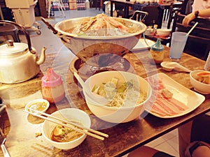 Steamboat hot pot with different ingredients in Chinese restaurant