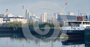 Steamboat moored on the River Clyde and construction activity in background