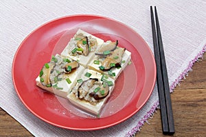 Steamed bean curd with herb in oyster sauce, Chinese cuisine.