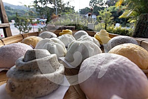 Steamed bun,yellow Steamed bun ,purple Steamed bun on bamboo basket in morning closeup view