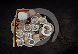 Steamed buns with minced pork filling and Pork shumai or Chinese steamed dumpling served with sour sauce