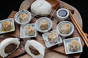 Steamed buns with minced pork filling and Pork shumai or Chinese steamed dumpling served with sour sauce