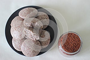 Steamed cakes made with finger millets and skinned black gram. Locally known as Ragi idli