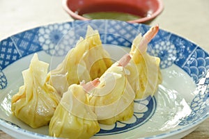 steamed Chinese dumpling filling mashed pork and shrimp or dim sum on plate dipping sour soy sauce