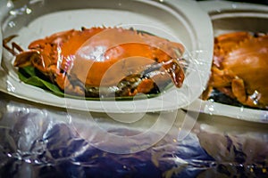 Steamed crab for sale at the seafood restaurant. Boiled crab for sale that wrapped with plastic and ready to bring back home.