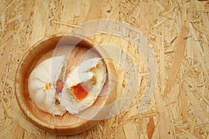 Steamed dumpling - chinese bun on brown background.