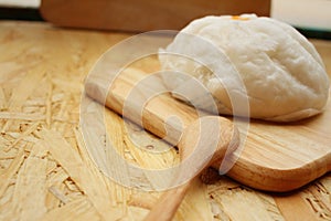 Steamed dumpling - chinese bun on brown background.