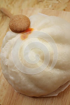 Steamed dumpling - chinese bun on brown background.