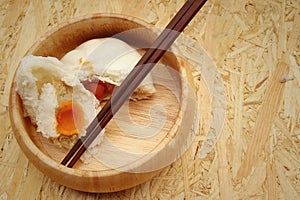 Steamed dumpling - chinese bun on brown background.