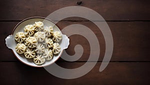 Steamed Dumplings in a Bowl on a Wooden Table Top View, Copy Space