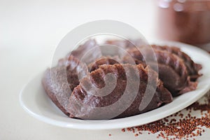 Steamed dumplings made from finger millet flour. It is stuffed with coconut and jaggery to make it sweeter