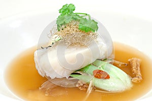 Steamed fillet of cod on a bed of vegetables