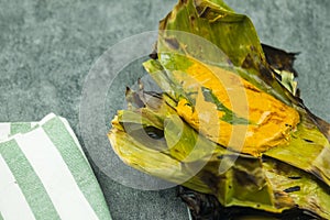 Steamed fish with curry paste wrap in banana leaf. It is popular Thai food