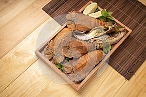 Steamed Flathead lobster with butter and lemon, Boiled Flathead lobster on wooden plate on wooden background