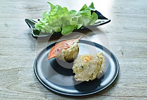 Steamed mashed crab meat and pork topping salty egg in flower crab shell eat couple vegetable on plate