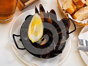 Steamed mussel served with lemon photo