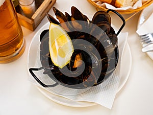 Steamed mussel served with lemon photo