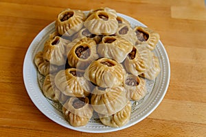 Steamed national Mongolian food dumpling Buuz filled with minced beef, white plate, wooden table, Close up east Siberian Buryats