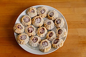 Steamed national Mongolian food dumpling Buuz filled with minced beef, white plate, wooden table, Close up east Siberian Buryats