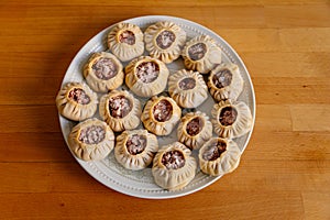 Steamed national Mongolian food dumpling Buuz filled with minced beef, white plate, wooden table, Close up east Siberian Buryats