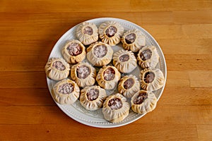 Steamed national Mongolian food dumpling Buuz filled with minced beef, white plate, wooden table, Close up east Siberian Buryats