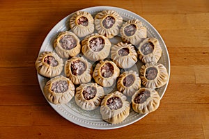 Steamed national Mongolian food dumpling Buuz filled with minced beef, white plate, wooden table, Close up east Siberian Buryats