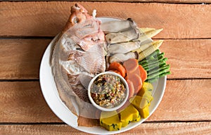 Steamed Nile tilapia fish and vegetables, served with sauce