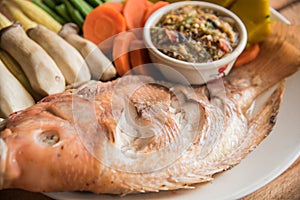 Steamed Nile tilapia fish and vegetables, served with sauce