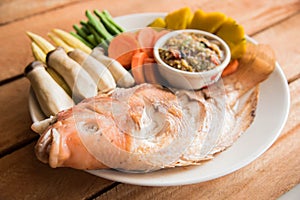 Steamed Nile tilapia fish and vegetables, served with sauce