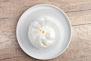 Steamed pork buns in a plate on a white background