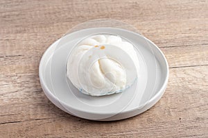 Steamed pork buns in a plate on a white background