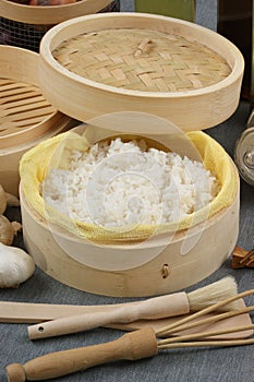Steamed rice in a bamboo steamer