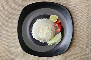Steamed rice with delicious boiled chicken, chili, lemon, and cucumber