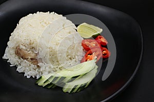 Steamed rice with delicious boiled chicken, chili, lemon, and cucumber