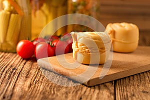 Steamed rolled cheese on wooden board