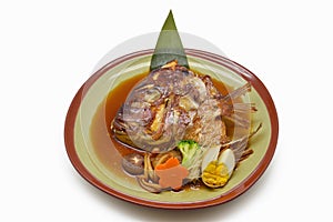 Steamed salmon Head with soy sauce in green plate Japanese style