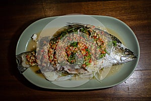 Steamed sea bass fish with lime and chili spicy soup