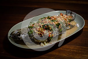 Steamed sea bass fish with lime and chili spicy soup