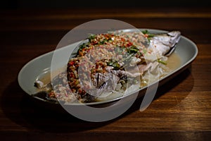 Steamed sea bass fish with lime and chili spicy soup